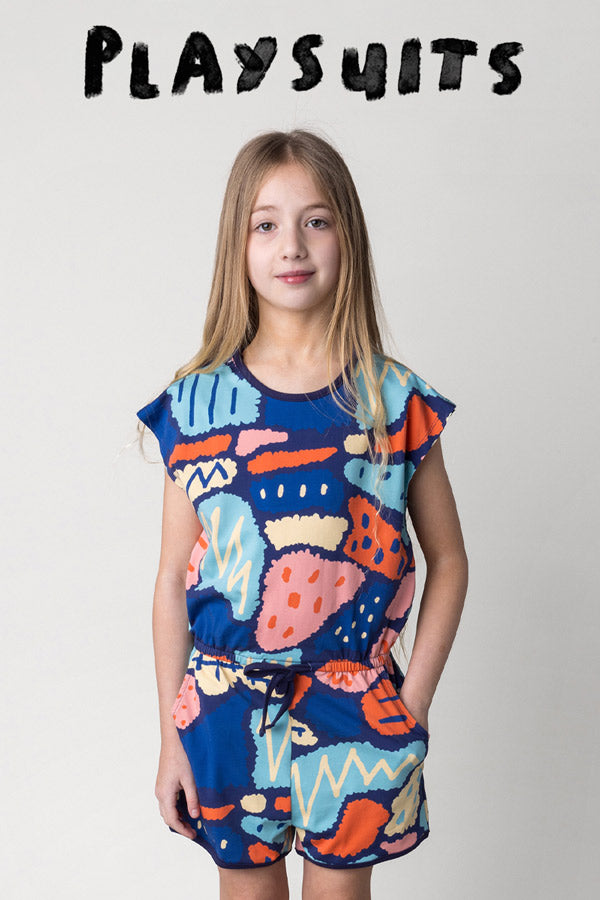 Shop playsuits at Minti, kid wearing the Cool Shapes Playsuit in dark blue