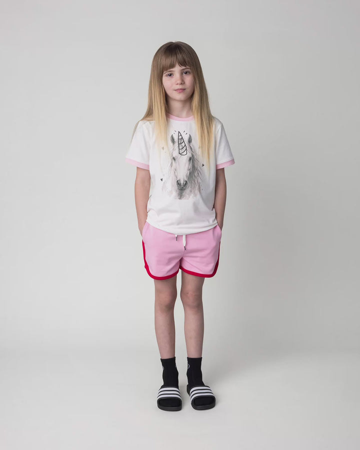 Kid wearing the Watercolour Unicorn Tee in white and pink, full circle video