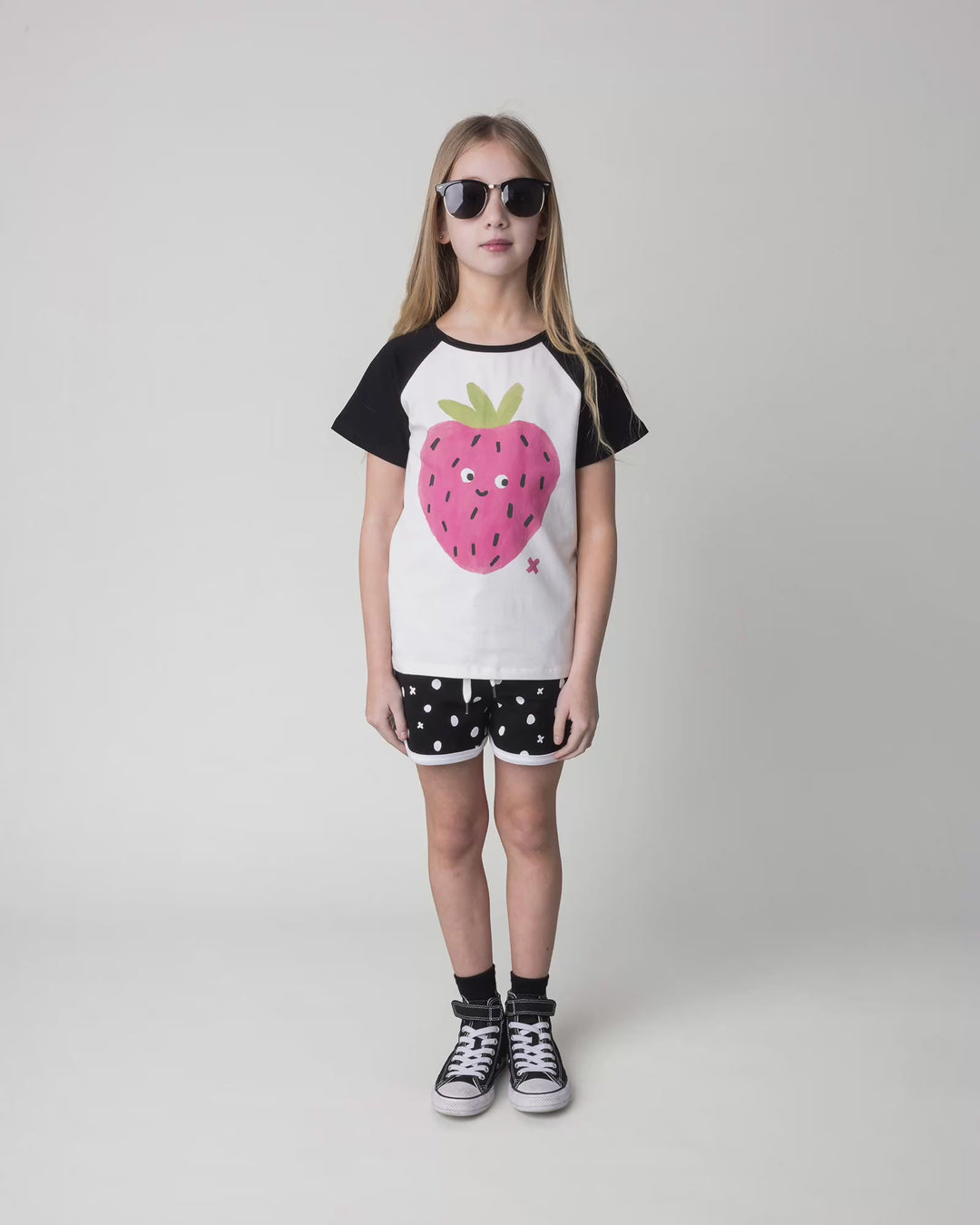 Kid wearing the Happy Strawberry Tee in white and black, full circle video