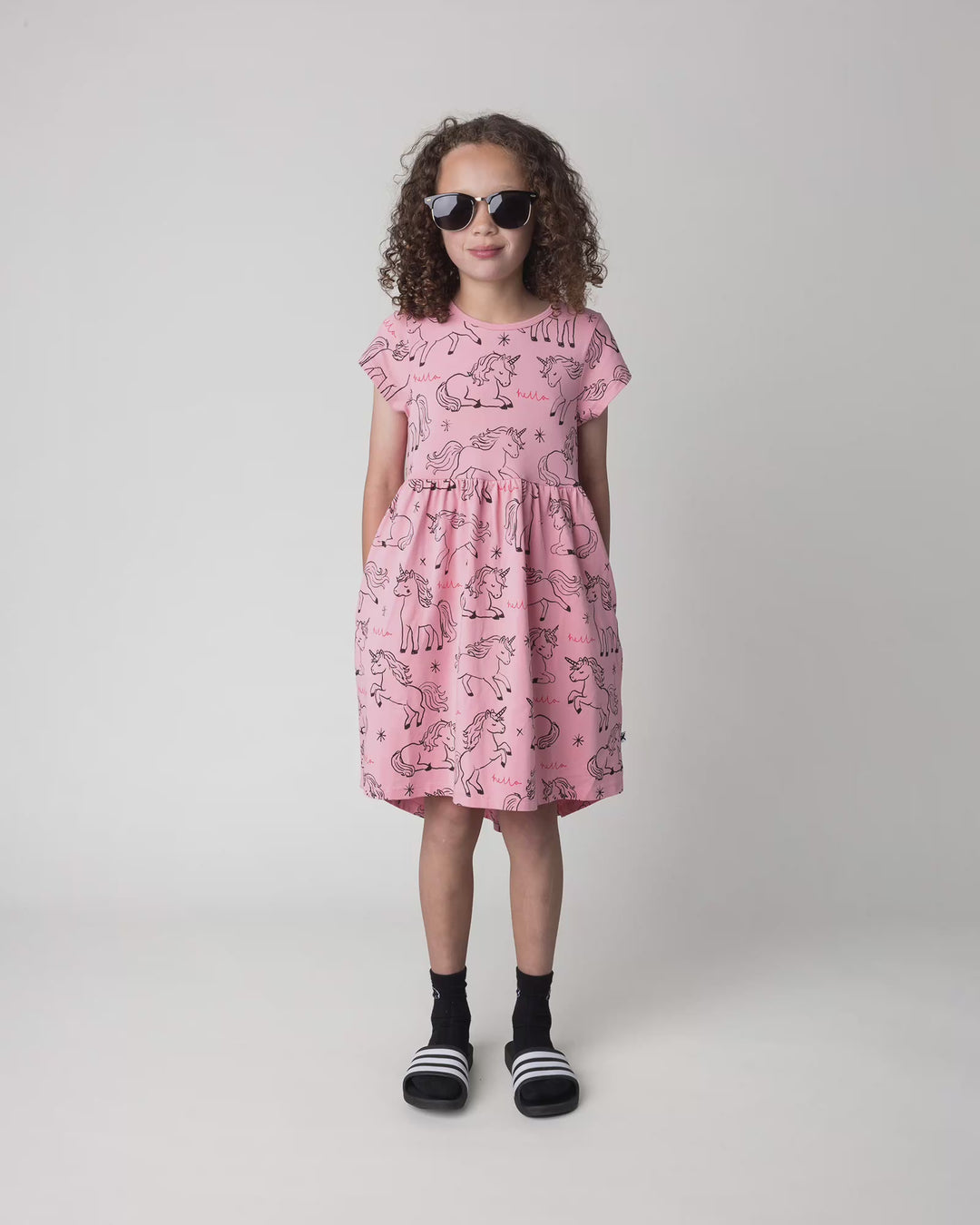 Kid wearing the Hello Unicorns Dress in pink, full circle video