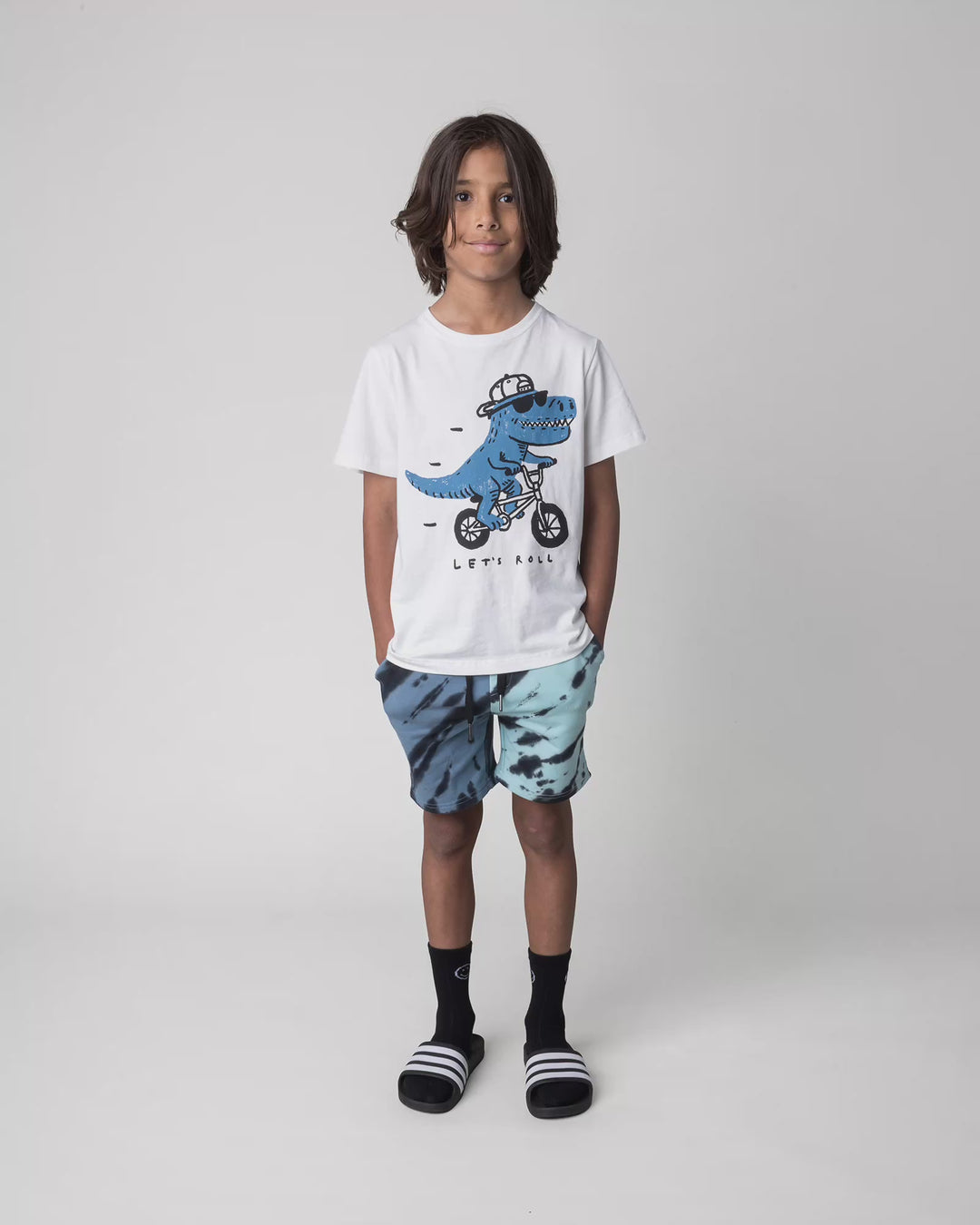 Kid wearing the Rex Rider Tee in off white, full circle video