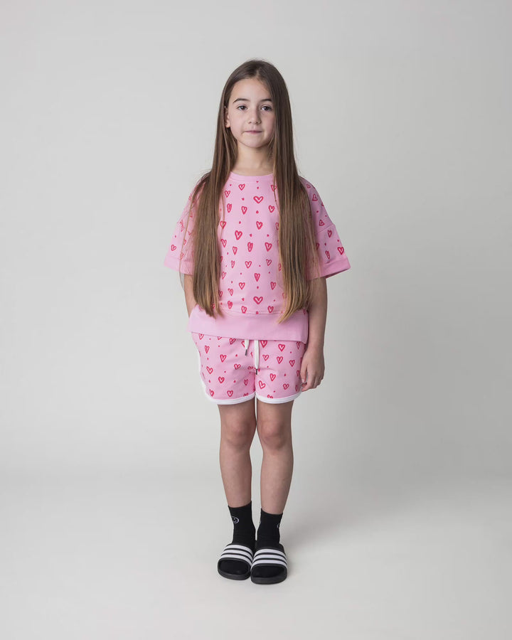 Kid wearing the Hearts Short in pink and white, full circle video