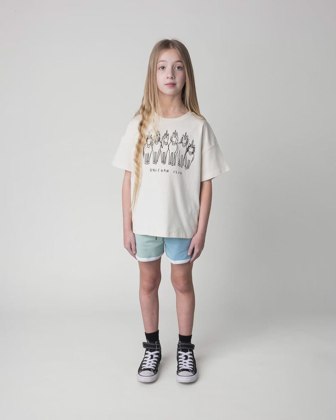 Kid wearing the Unicorn Club Tee in cream, full circle video