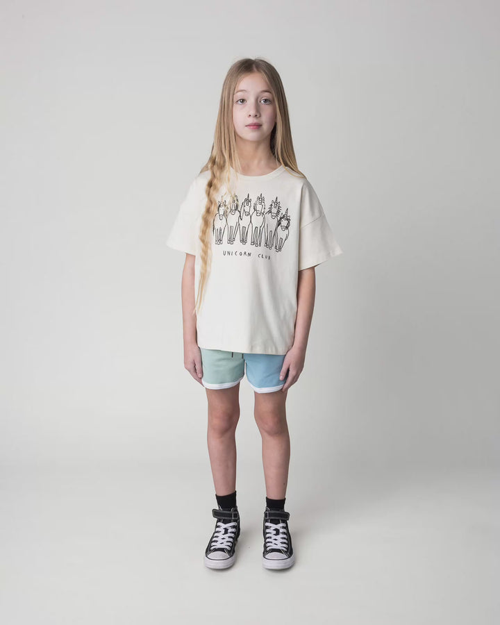 Kid wearing the Unicorn Club Tee in cream, full circle video