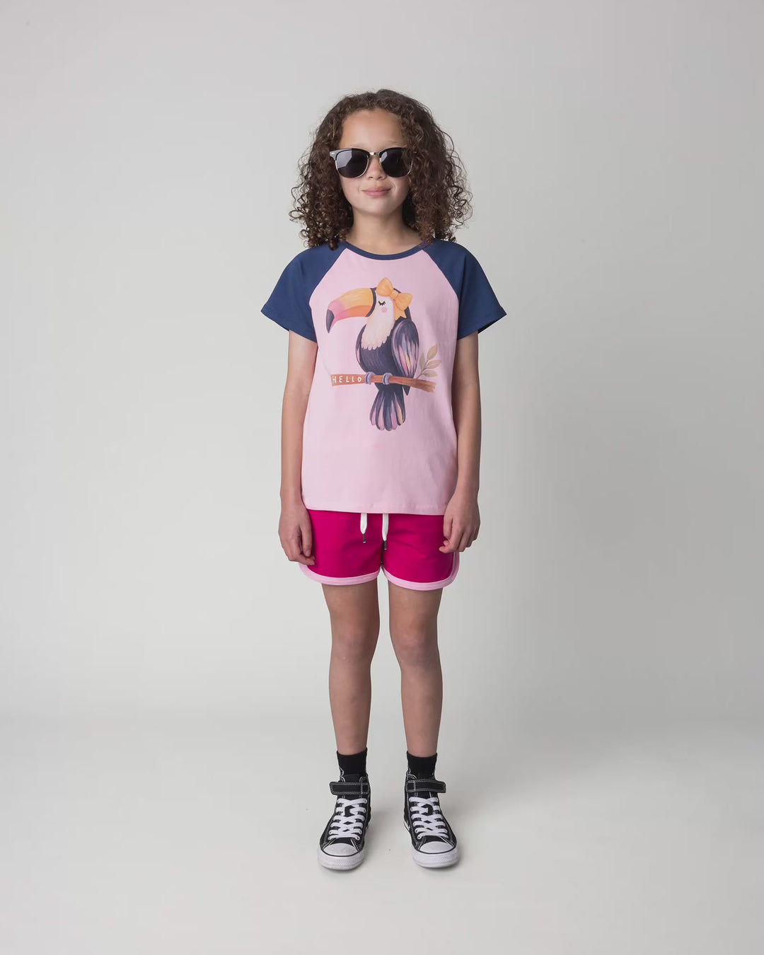 Kid wearing the Hello Toucan Tee in ballet and ink, full circle video