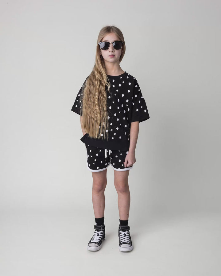Kid wearing the Spotty Short Sleeve Crew in black, full circle video