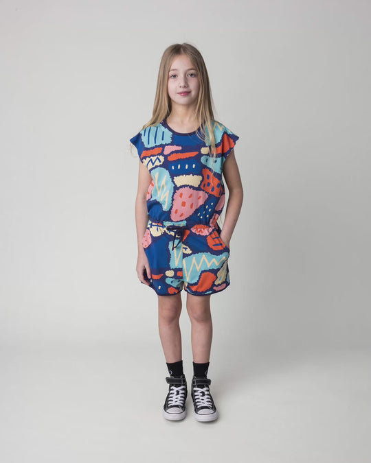 Kid wearing the Cool Shapes Playsuit in dark blue, full circle video