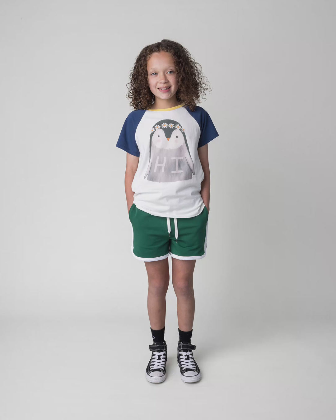 Kid wearing the Flower Penguin Tee in white, full circle video