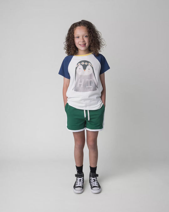 Kid wearing the Flower Penguin Tee in white, full circle video