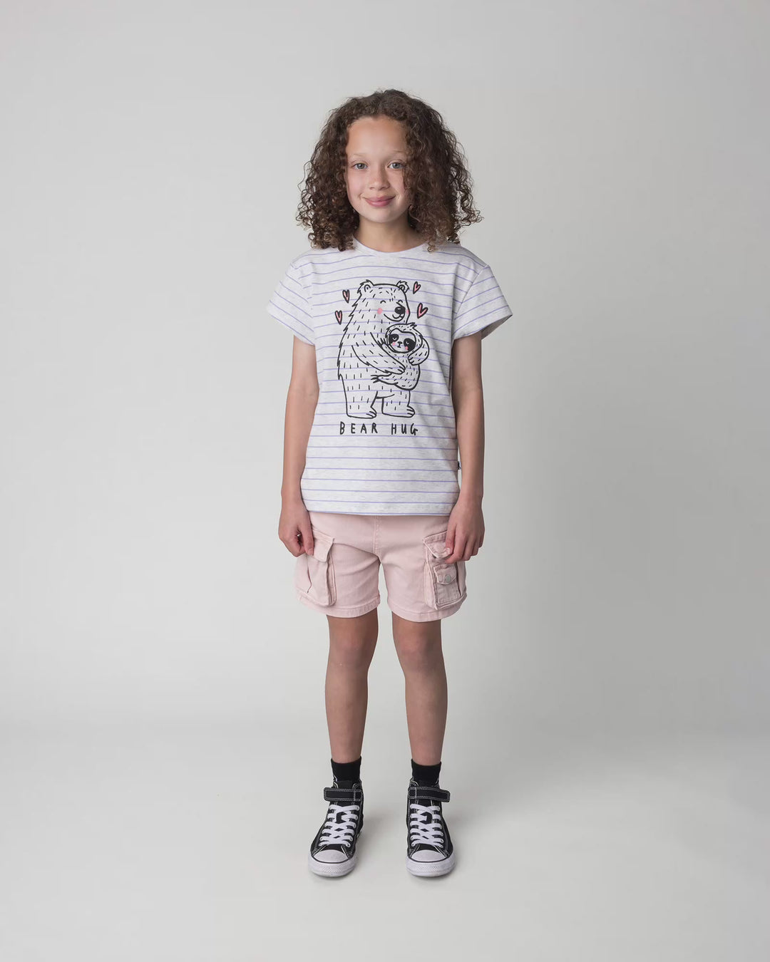 Kid wearing the Bear Hug Tee in marle and purple stripe, full circle video
