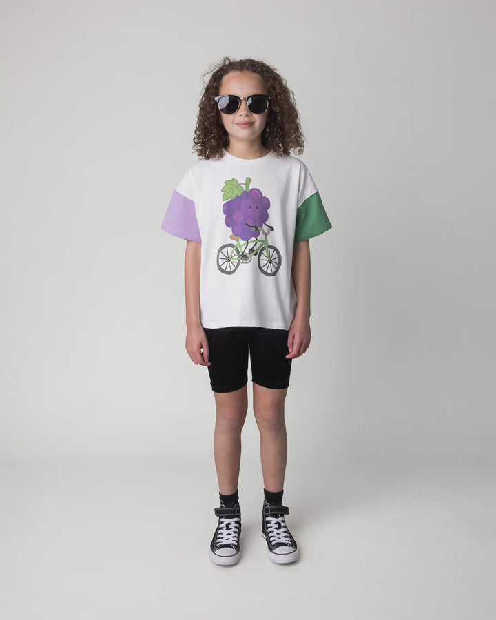 Kid wearing the Biking Grape Tee in white, full circle video