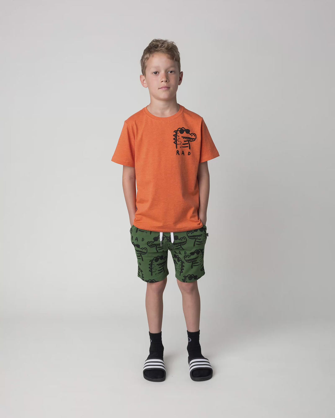 Kid wearing the Rad Croc Tee in orange marle, full circle video