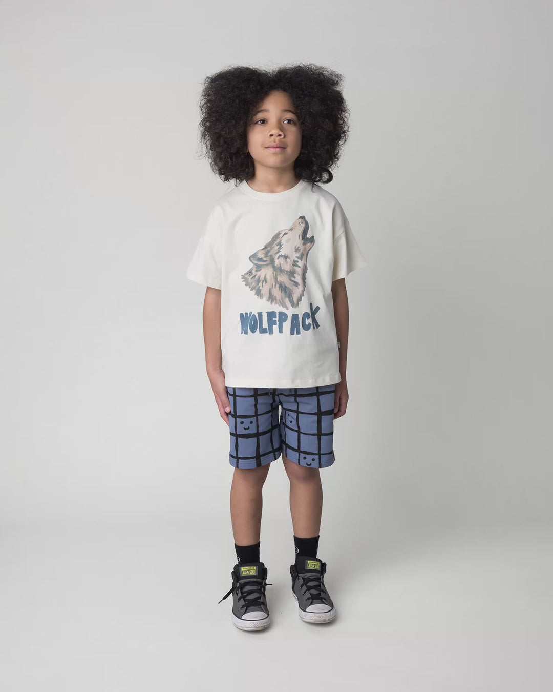 Kid wearing the Happy Squares Short in muted blue, full circle video
