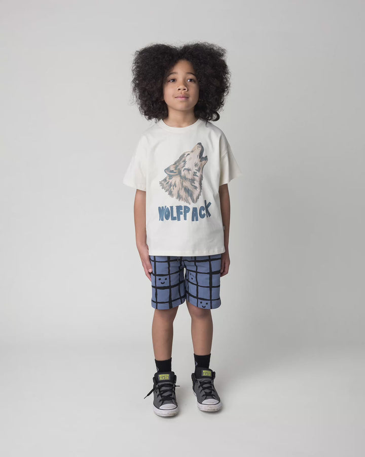 Kid wearing the Happy Squares Short in muted blue, full circle video