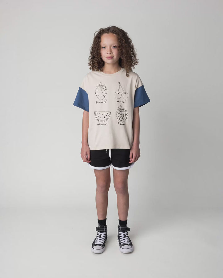 Kid wearing the Different Fruits Tee in stone and midnight, full circle video