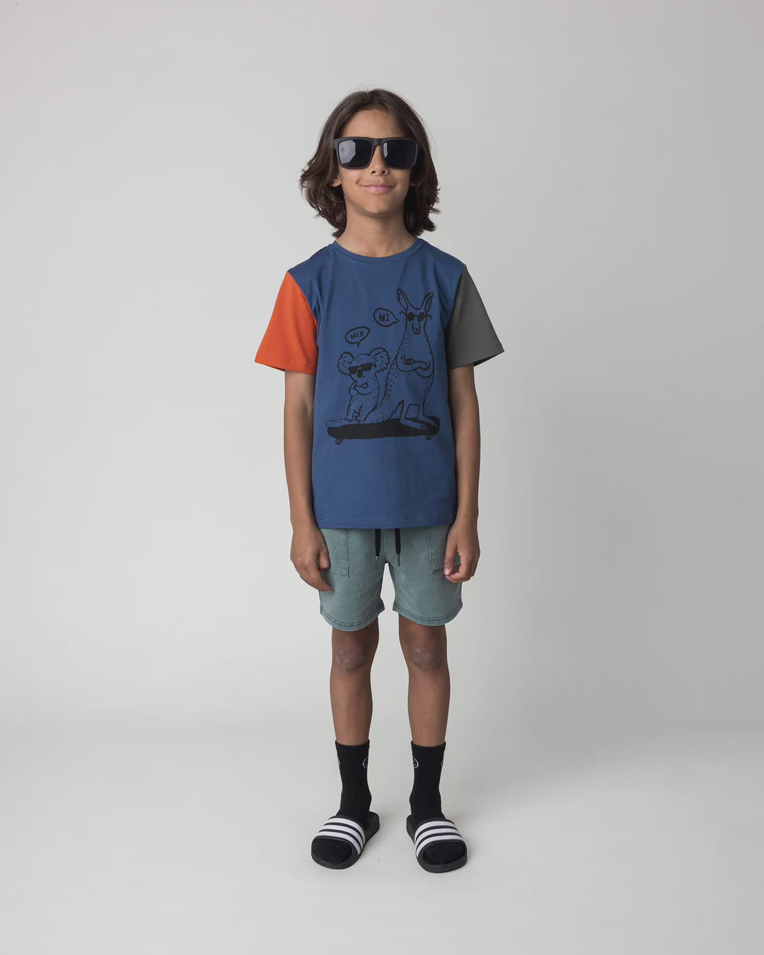 Kid wearing the Chill Mates Tee in midnight, full circle video