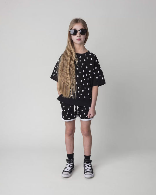 Kid wearing the Spotty Short in black and white, full circle video