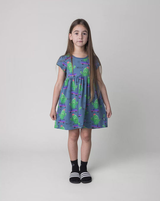 Kid wearing the Skate Cactus Dress in muted blue, full circle video