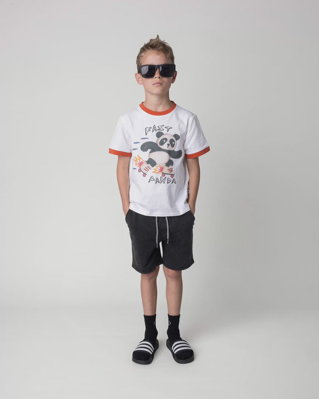 Kid wearing the Fast Panda Tee in white and orange, full circle video