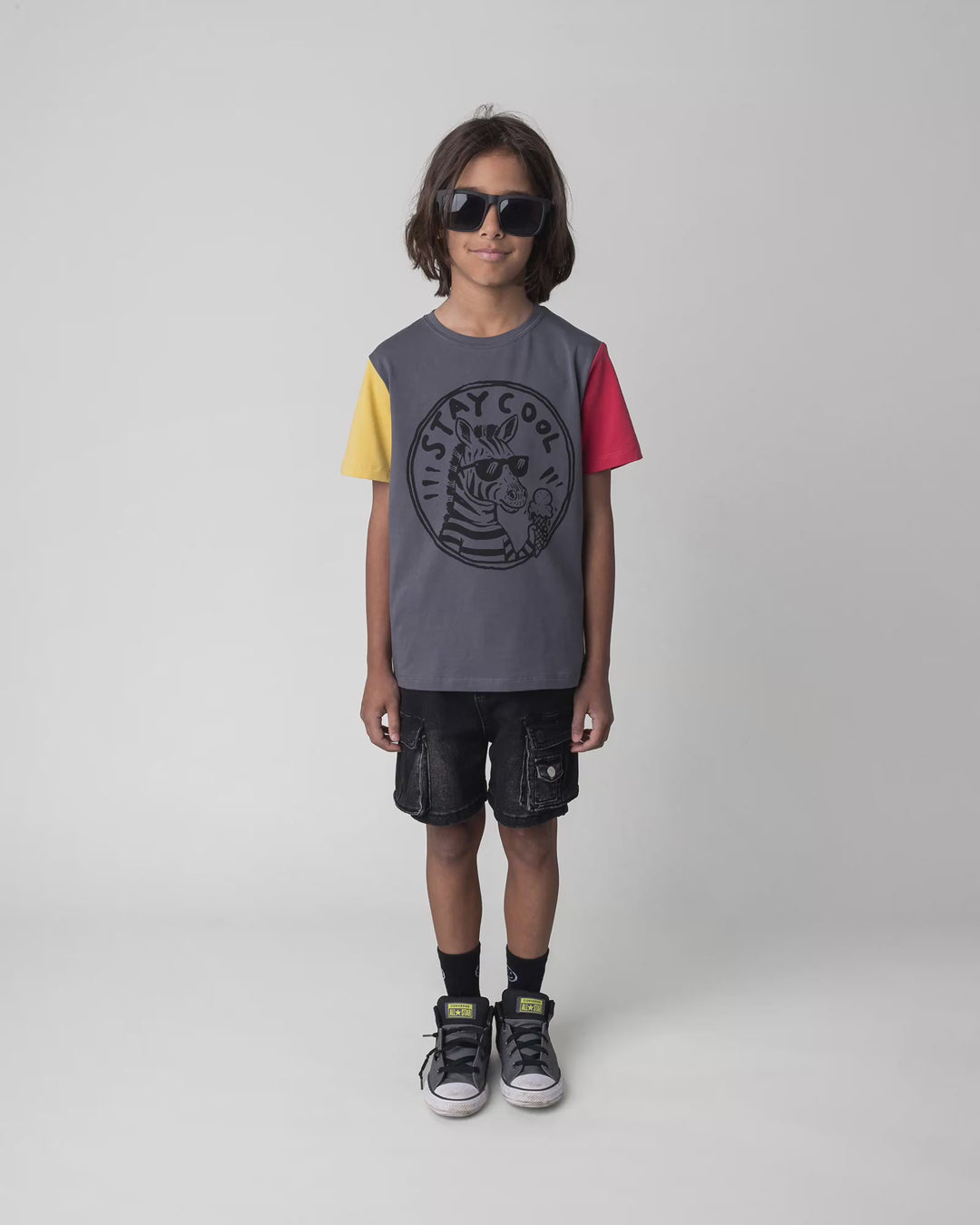 Kid wearing the Stay Cool Tee in dark grey, full circle video