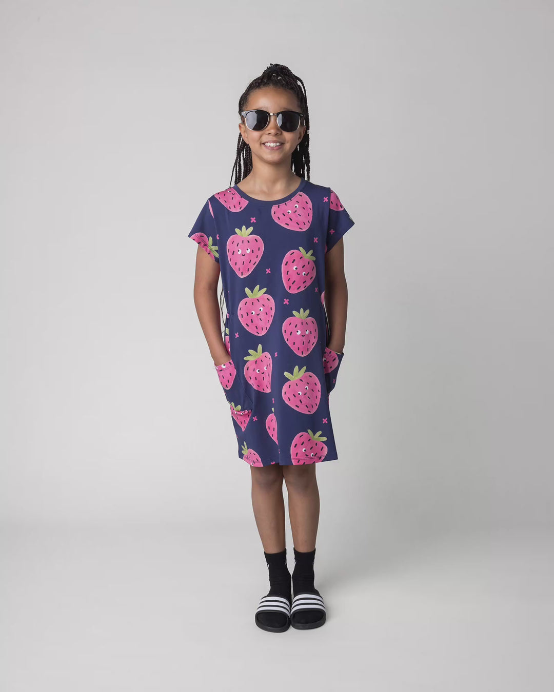 Kid wearing the Happy Strawberry Dress in turquoise, full circle video
