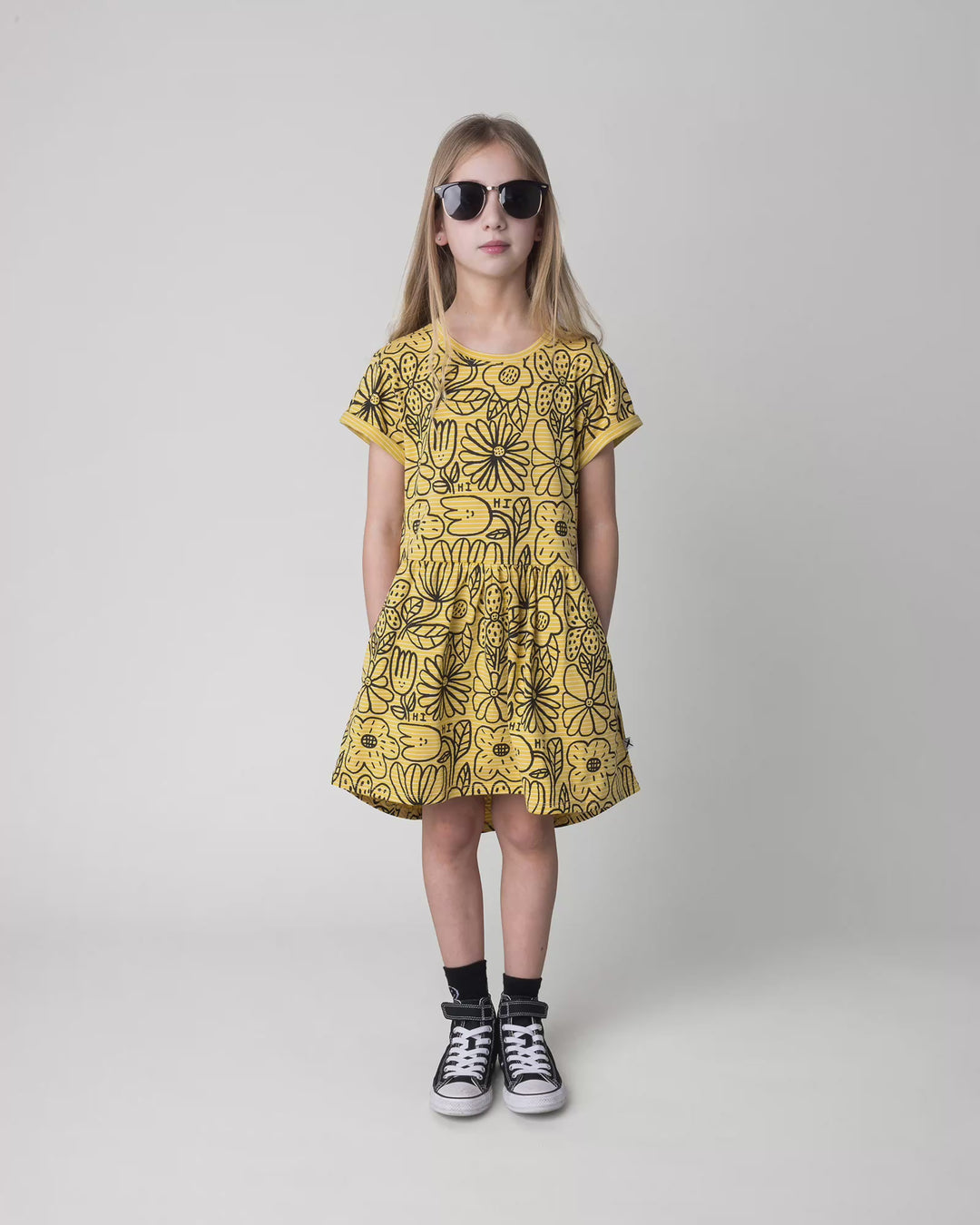 Kid wearing the Big Flowers Dress in mustard stripe, full circle video