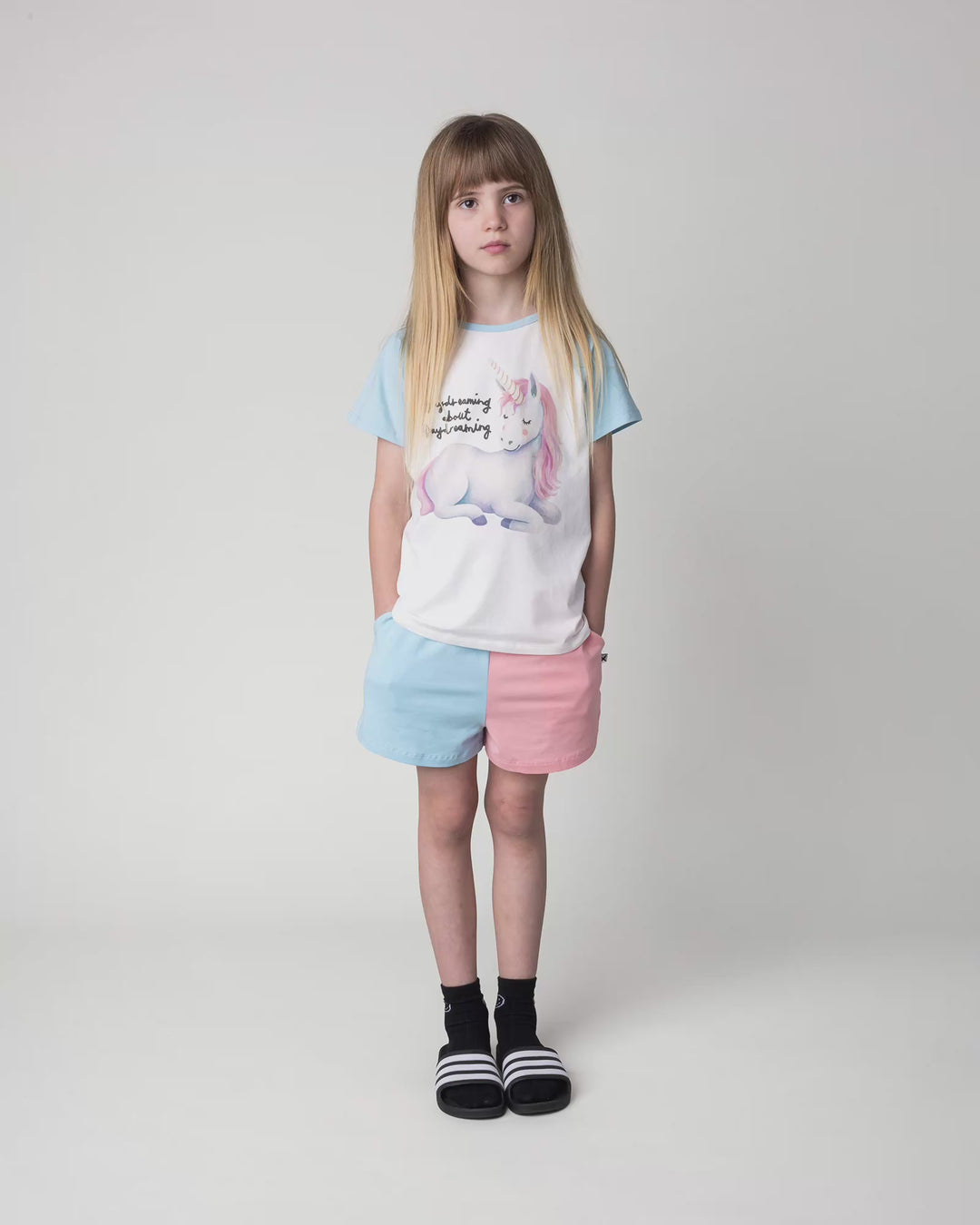 Kid wearing the Daydreaming Unicorn Tee in white and light blue, full circle video