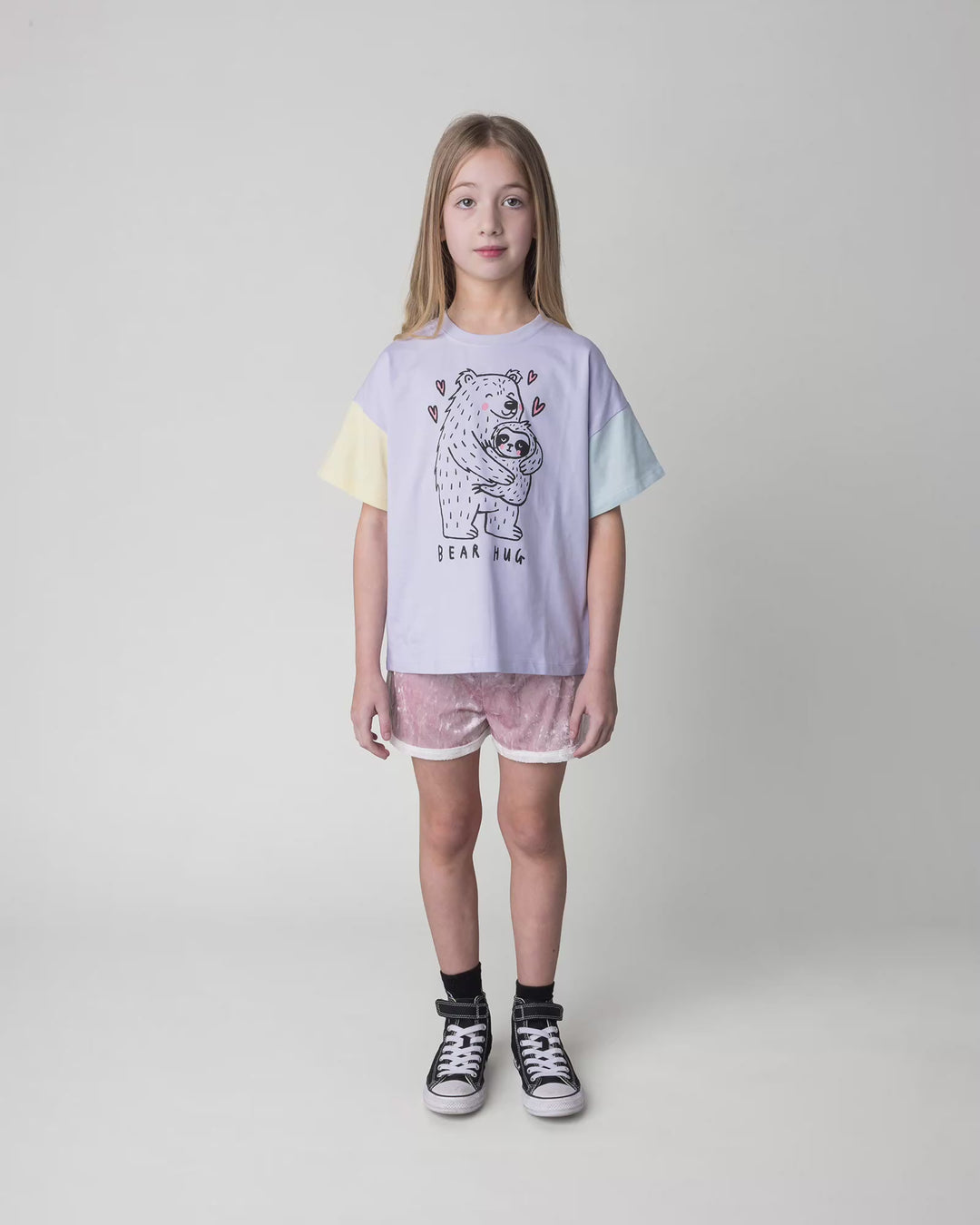 Kid wearing the Bear Hug Tee in lilac, full circle video