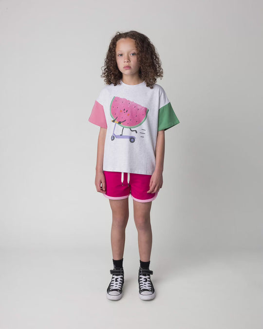 Kid wearing the Sprint Short in crimson and pink, full circle video
