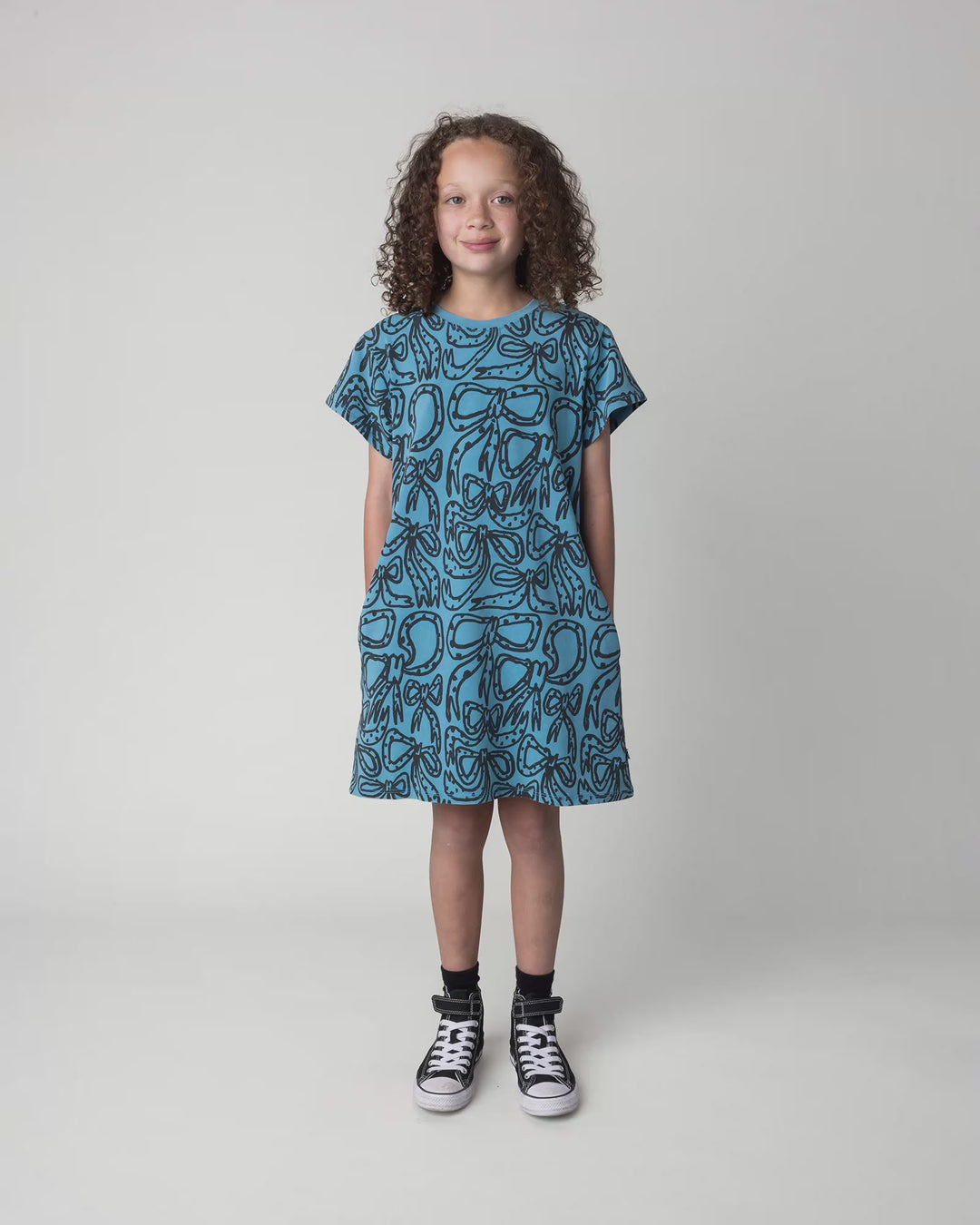 Kid wearing the Big Bows Dress in blue wash, full circle video