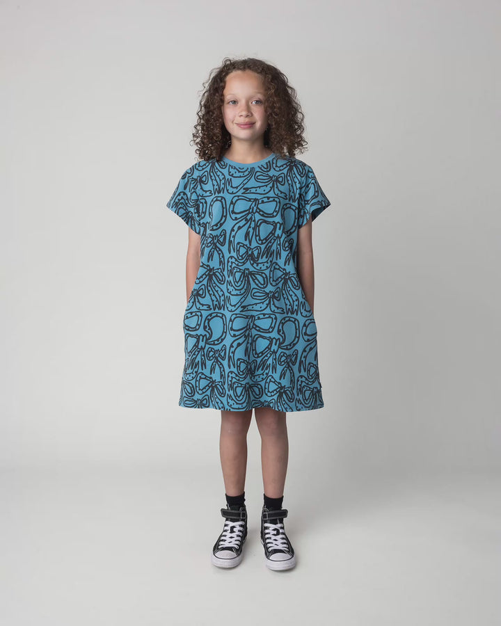 Kid wearing the Big Bows Dress in blue wash, full circle video
