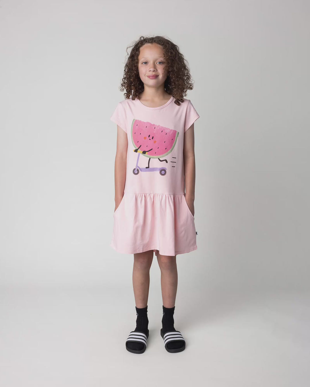Kid wearing the Scooting Watermelon Dress in light pink, full circle video