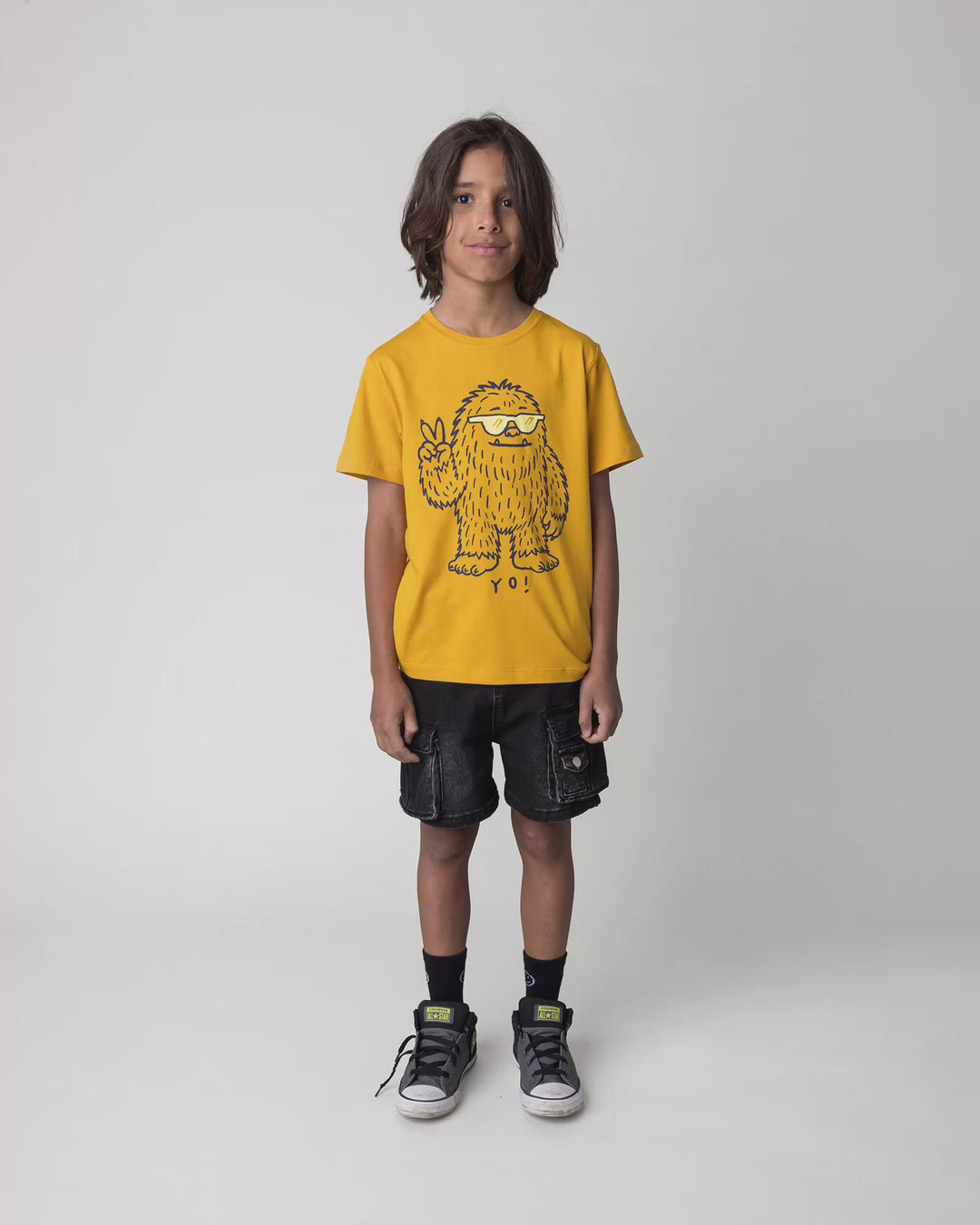 Kid wearing the Yo Yeti Tee in mustard, full circle video
