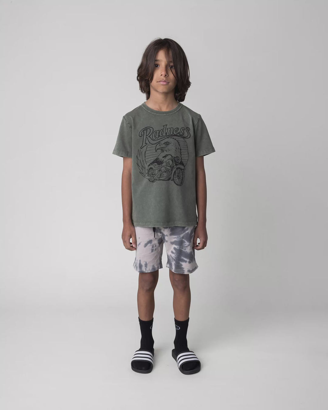 Kid wearing the Radness Tee in olive wash, full circle video