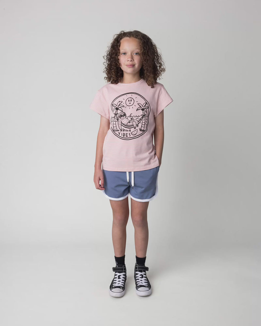 Kid wearing the Chill Sloth Tee in ballet stripe, full circle video