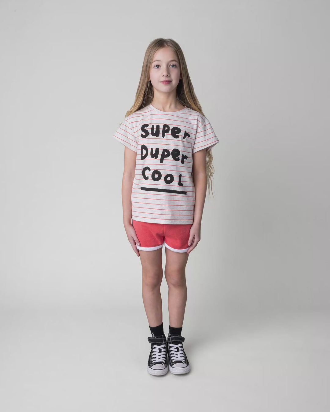 Kid wearing the Super Duper Cool Tee in marle and coral stripe, full circle video