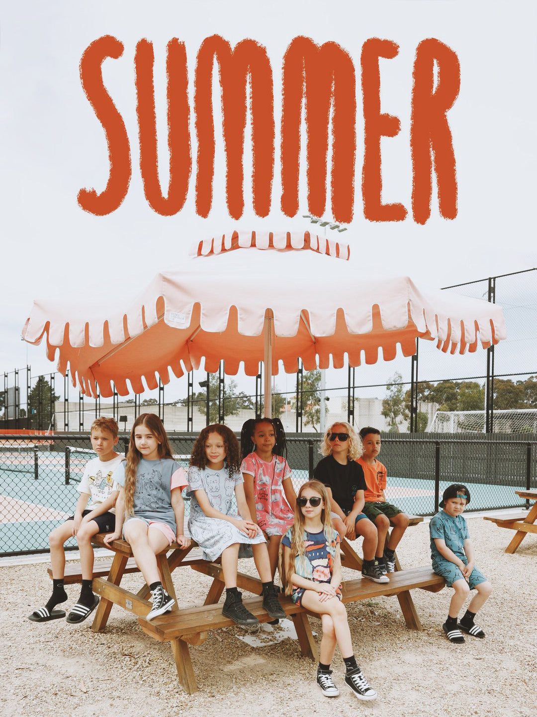 Kids sitting on a picnic table in Minti summer clothes