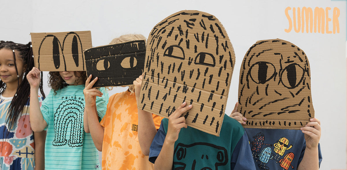 Kids in Minti summer tees holding hand drawn cardboard masks
